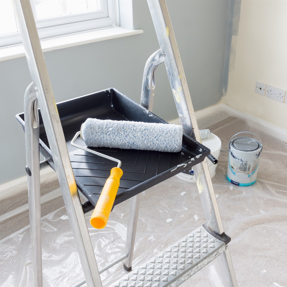 Painting supplies and ladder inside of house