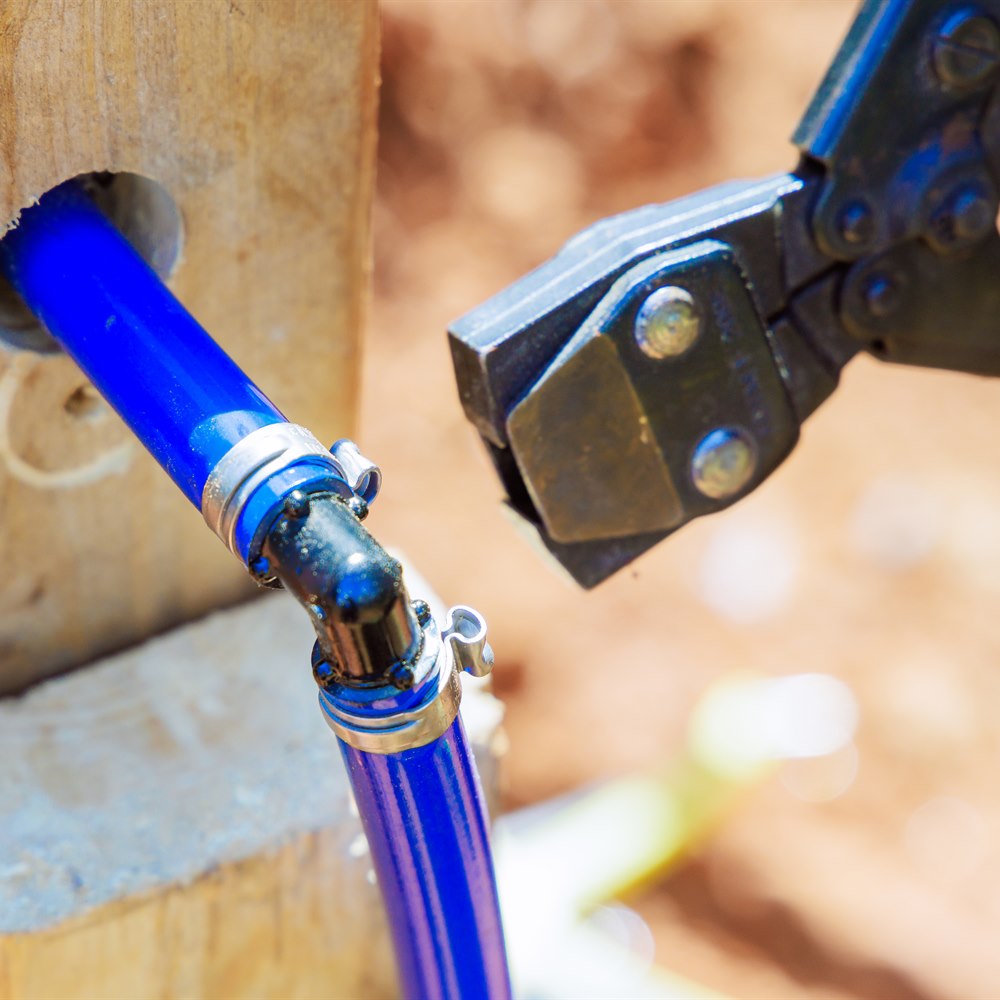pipe-being-installed-with-tool-in-bright-sunlight Pipe being installed with tool in bright sunlight