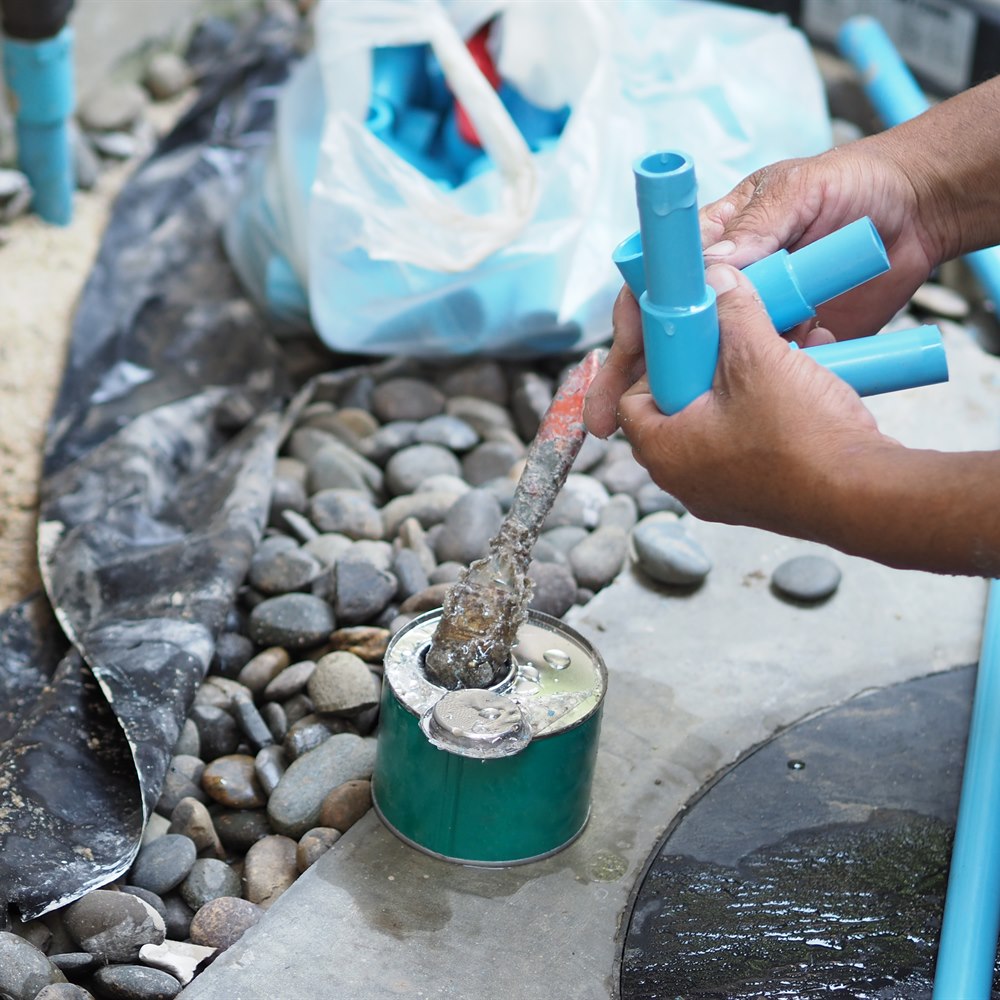 plumber-assembling-plastic-pipes-for-repairing-wat Plumber assembling plastic pipes for repairing water