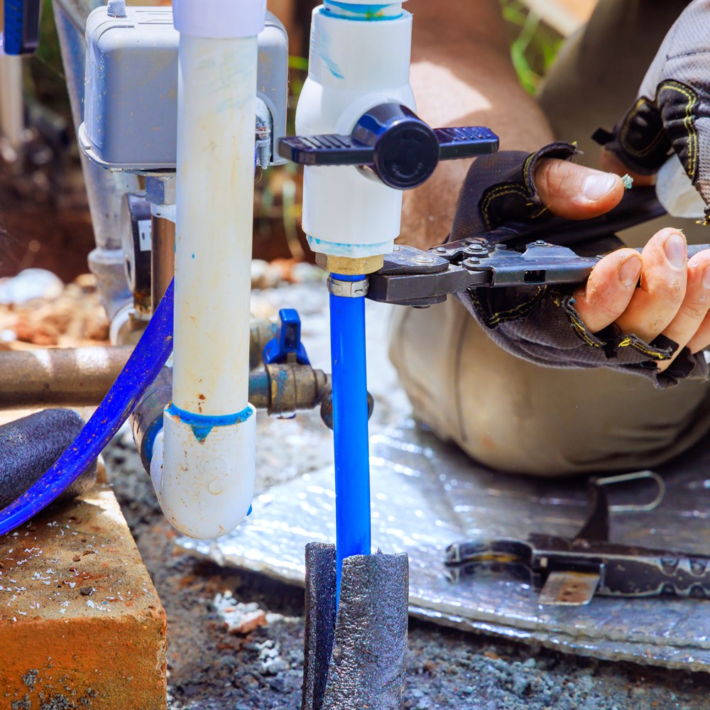 plumber-working-on-water-pipe-repair-project-2026 Plumber working on water pipe repair project