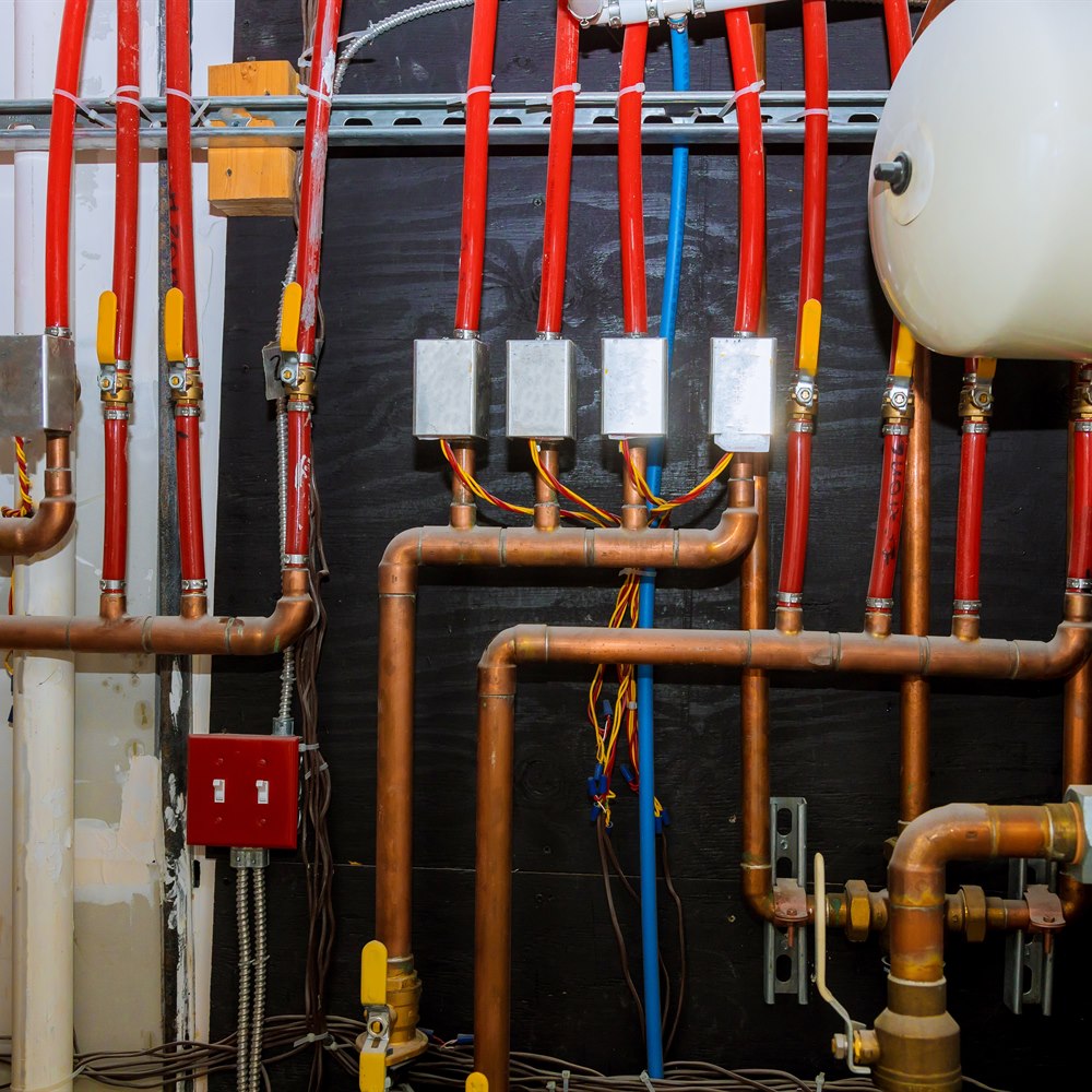 Plumbing system with copper and red pipes