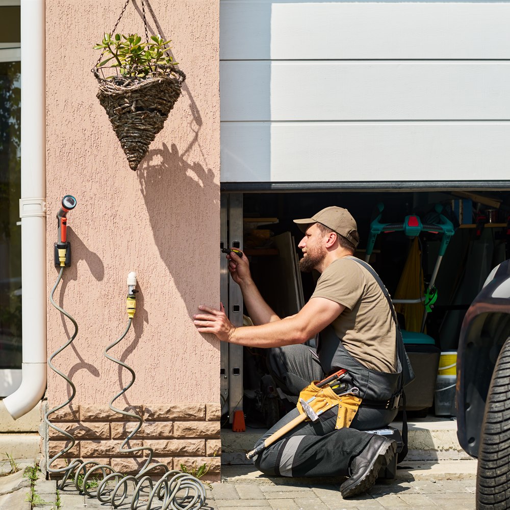 Professional handyman repairing a white residential