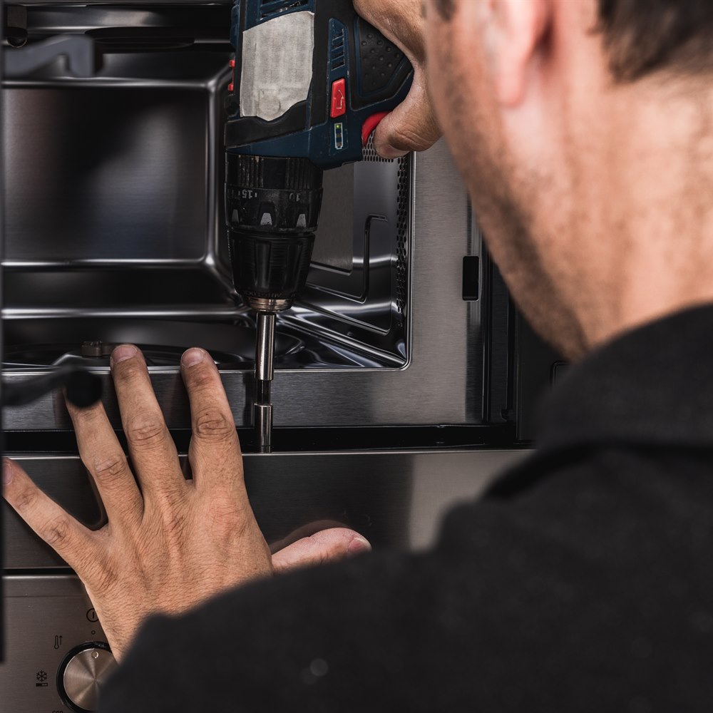 Repairing microwave oven with power drill tool