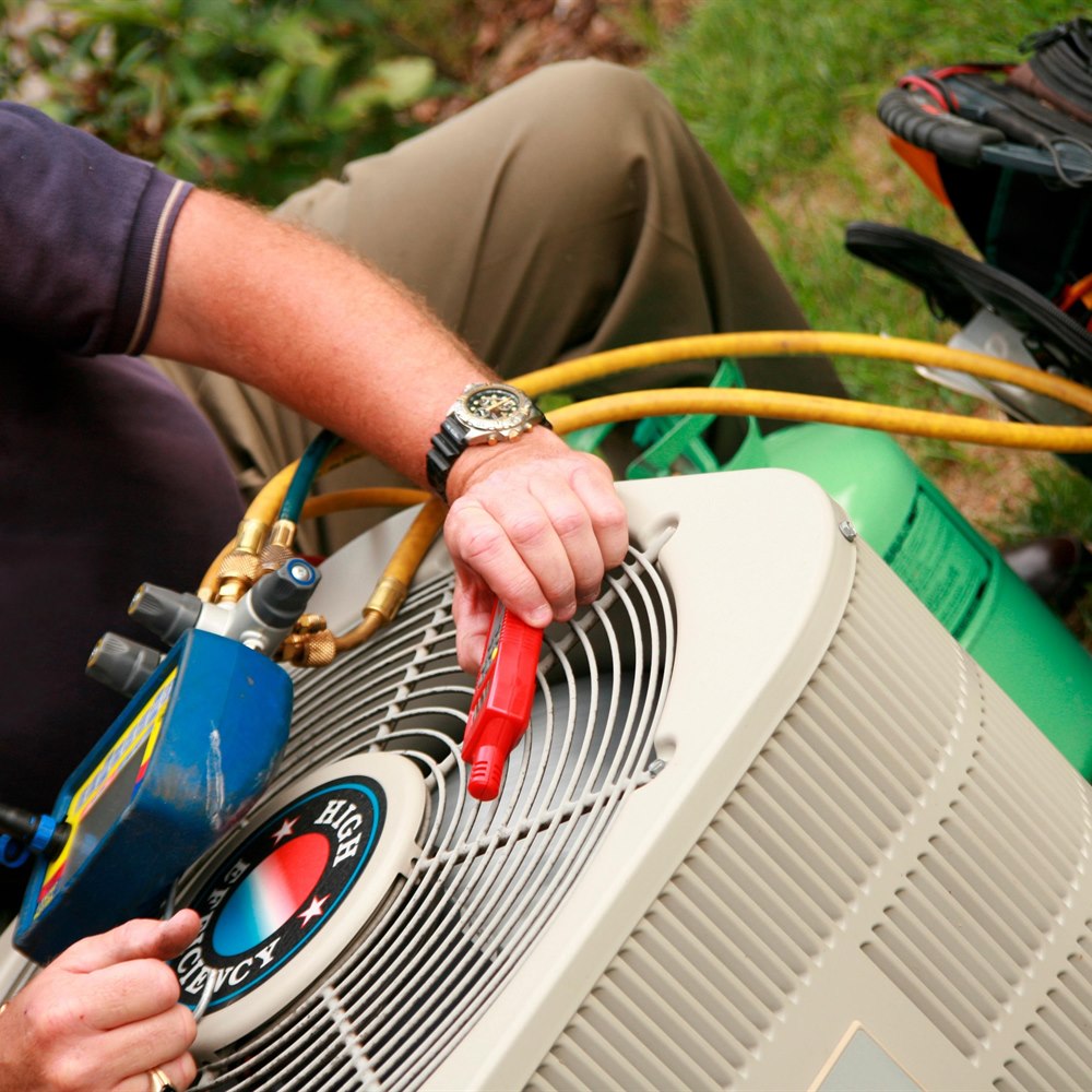 repairman-fixing-air-conditioner-outside-a-house Repairman fixing air conditioner outside a house