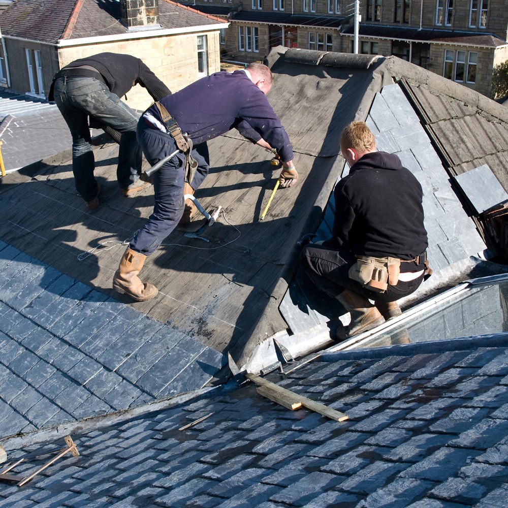 Roofers working on slate roof