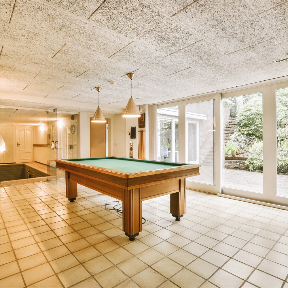Room with a pool table and small pool
