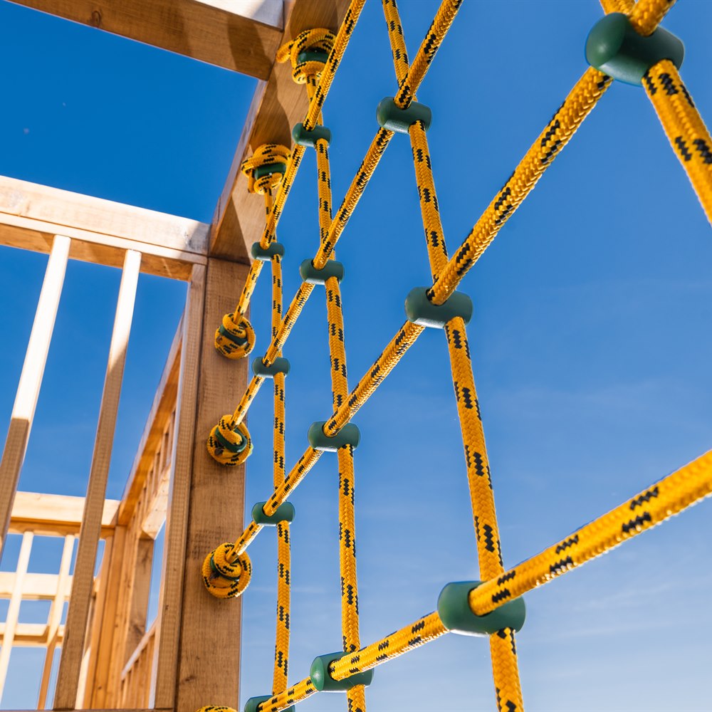 Rope climbing frame against a blue sky