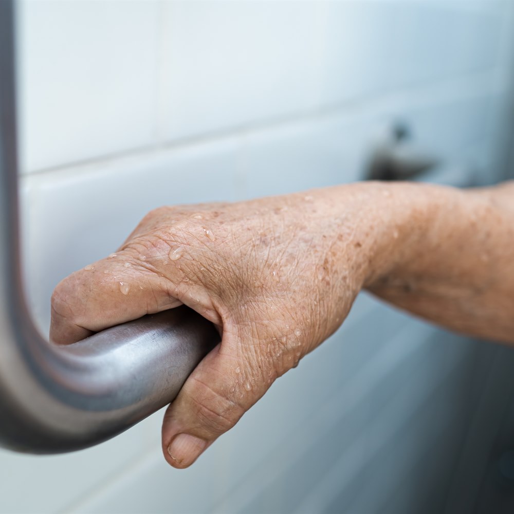 Senior using a shower grab bar