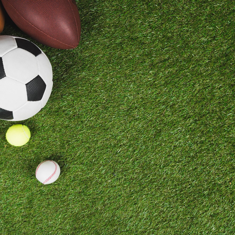 Sports equipment on green grass background