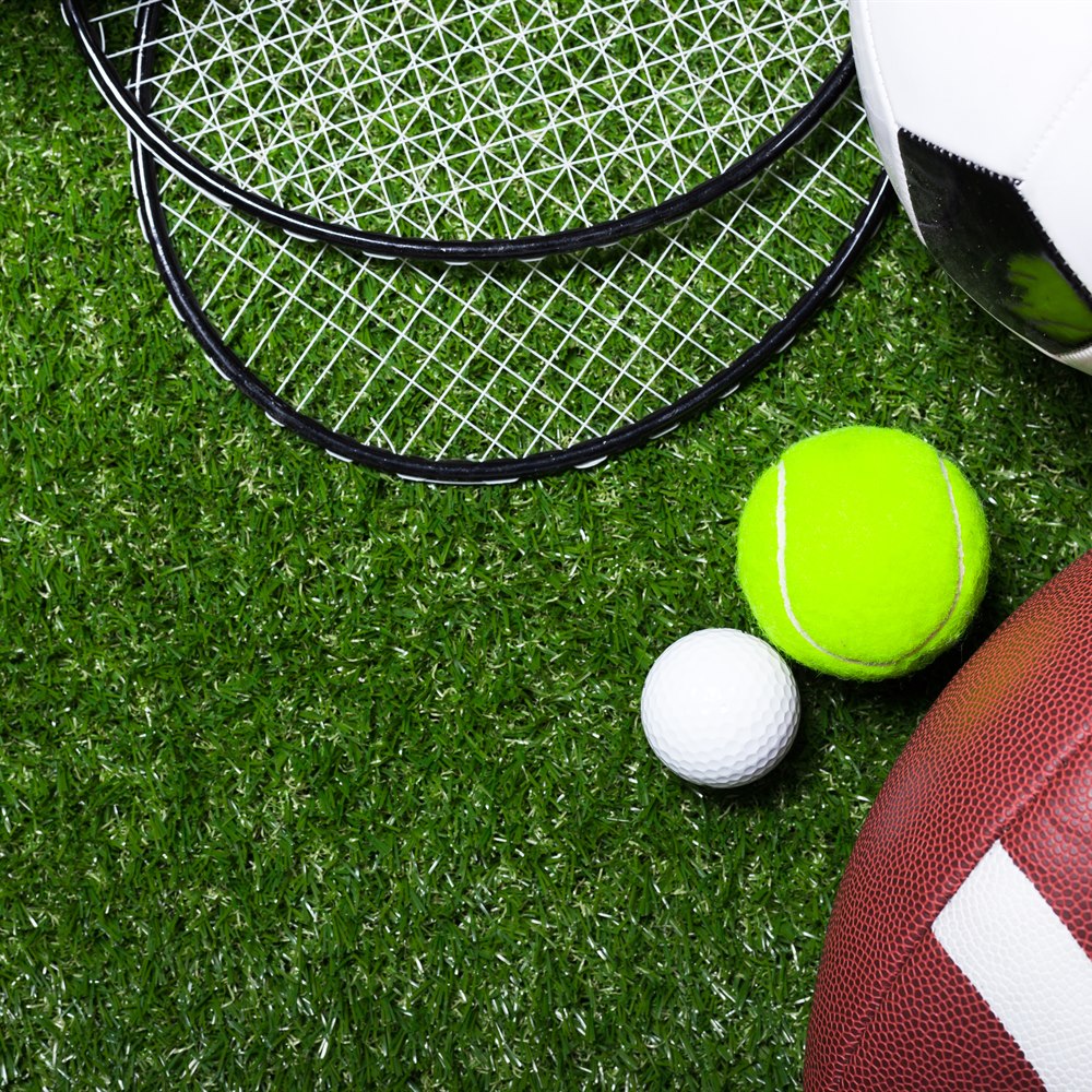 Sports equipment on green grass background