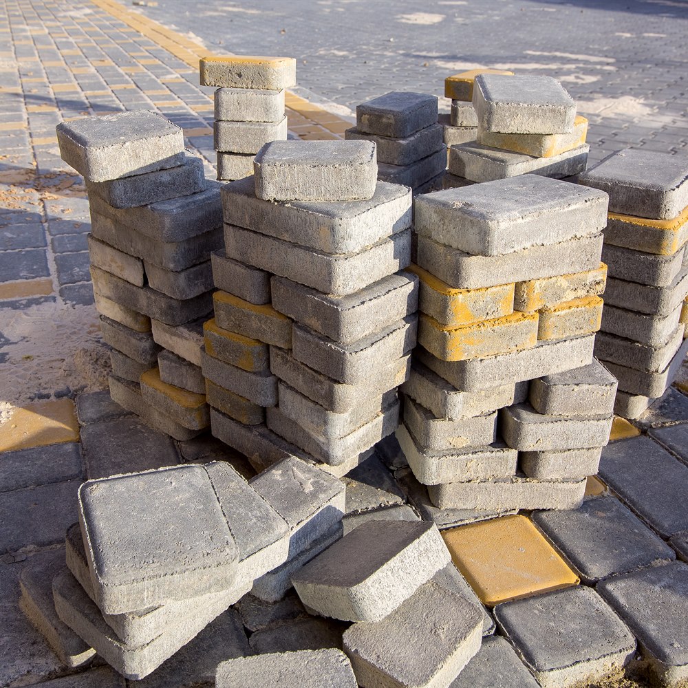 Stacks of gray and yellow pavers