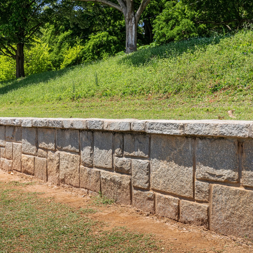 Stone retaining wall along a slope