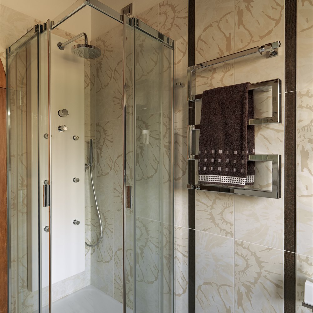 Stylish bathroom with shower and heated towel rack