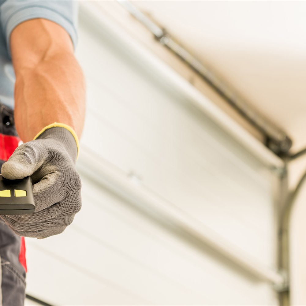 technician-with-garage-door-opener-remote Technician with garage door opener