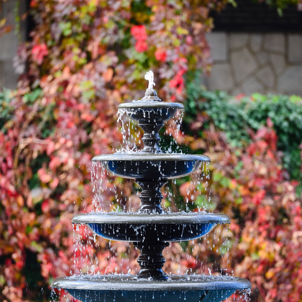 Tiered fountain with autumn foliage background