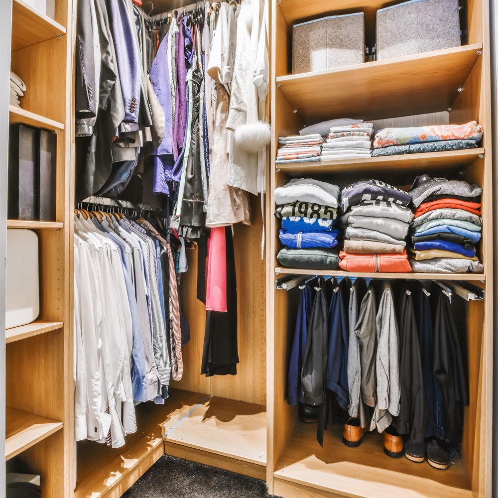 Walk in closet with wooden shelving