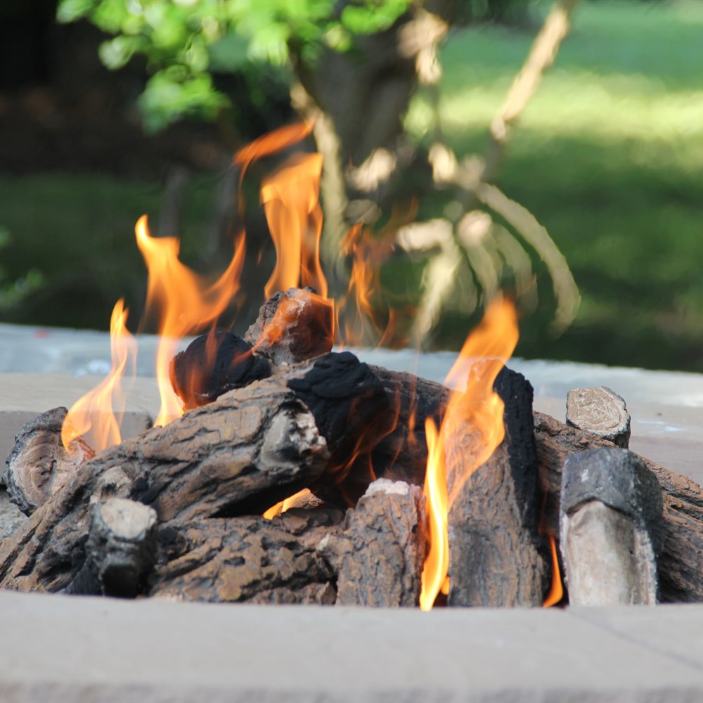 warm-fire-burning-with-green-nature-background Warm fire burning with green nature background