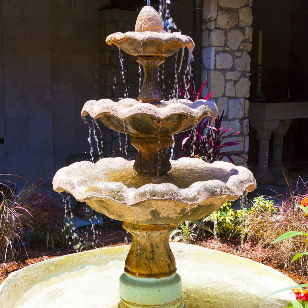 Water fountain in courtyard with stone architecture