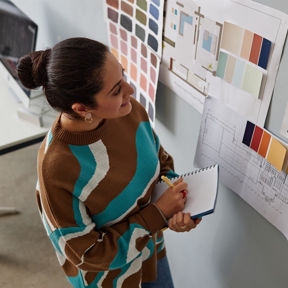 Woman designs architecture interiors in office